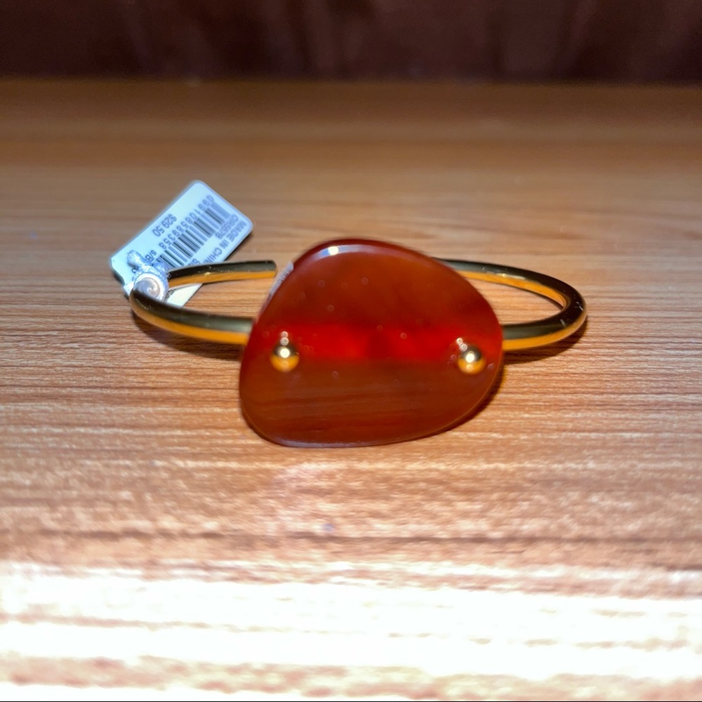 Cuff with beautiful acetate stone and gold plated detailing.